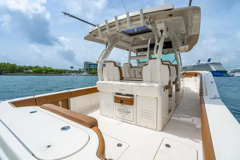 Slide: The Image of 2018 Scout 420 LXF boat on water, featuring luxurious seating and modern design. - 39