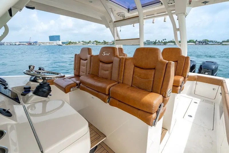 Slide: The Image of 2018 Scout 420 LXF boat interior with luxurious brown leather seating. - 41