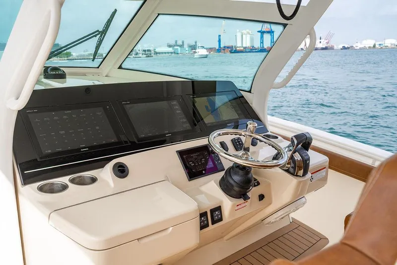 Slide: The Image of Helm of 2018 Scout 420 LXF boat with modern navigation displays and steering wheel. - 43