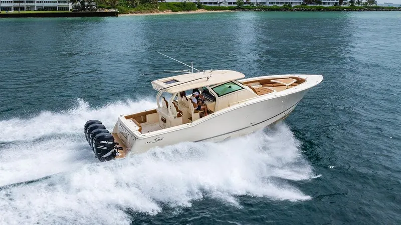 Slide: The Image of 2018 Scout 420 LXF boat cruising on water with powerful Mercury engines. - 5