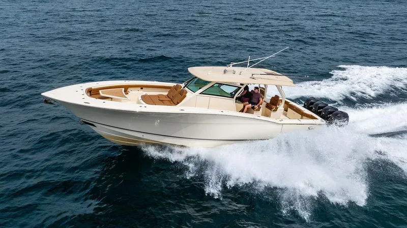 Slide: The Image of 2018 Scout 420 LXF boat cruising on open water, showcasing luxury and performance. - 7
