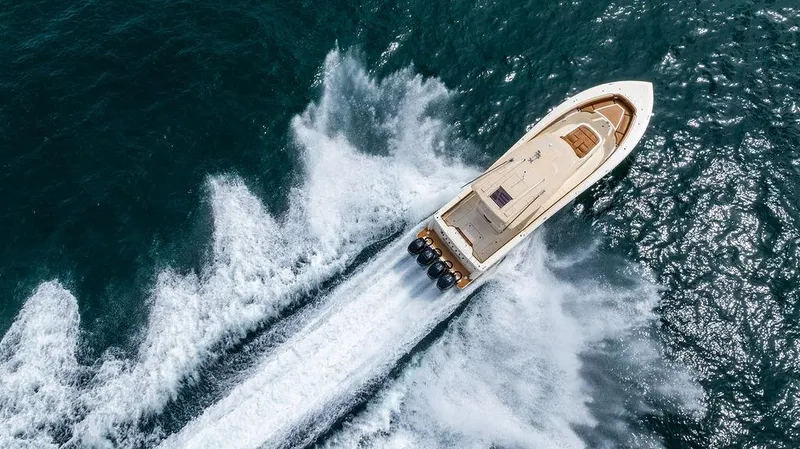 Slide: The Image of Aerial view of 2018 Scout 420 LXF boat speeding on ocean waters. - 8