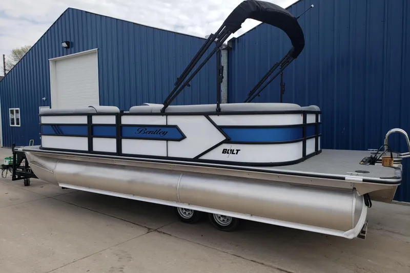 Slide: The Image of 2025 Bentley Pontoons 223 Bolt interior with steering console on a lake. - 8