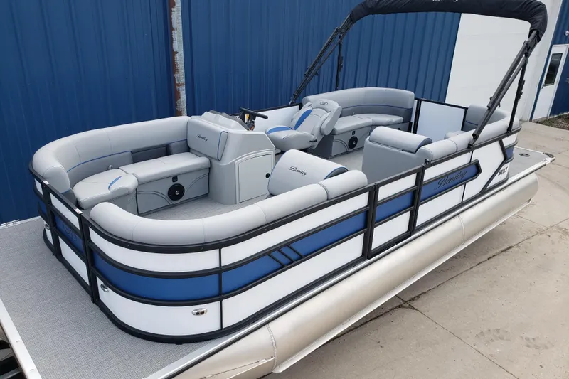 Slide: The Image of 2025 Bentley Pontoons 223 Bolt interior with luxurious seating on a calm lake. - 9