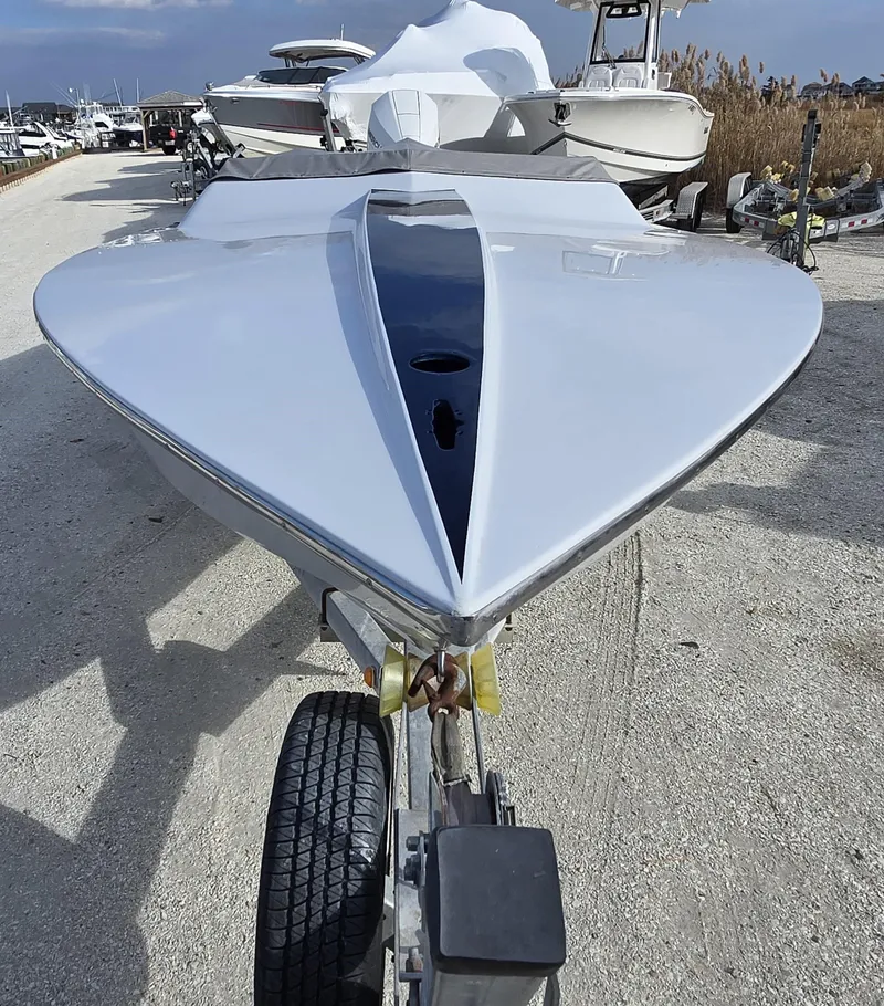 Slide: The Image of 1991 Activator 22 speedboat on trailer, sleek design, parked outdoors. - 12