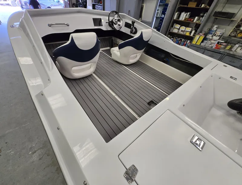 Slide: The Image of Interior of a 1991 Activator 22 boat with two seats and a steering wheel. - 15