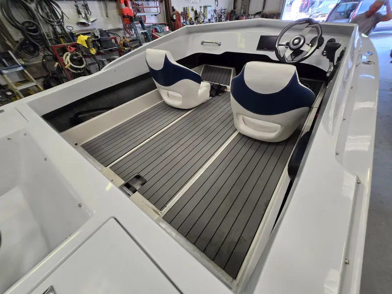 Slide: The Image of Interior of a 1991 Activator 22 boat with two seats and steering wheel. - 16