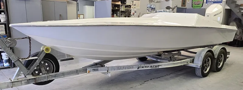 Slide: The Image of 1991 Activator 22 speedboat on trailer in a garage setting. - 19