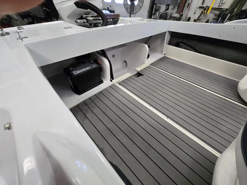 Slide: The Image of Interior of a 1991 Activator 22 boat showing battery compartment and seating area. - 21