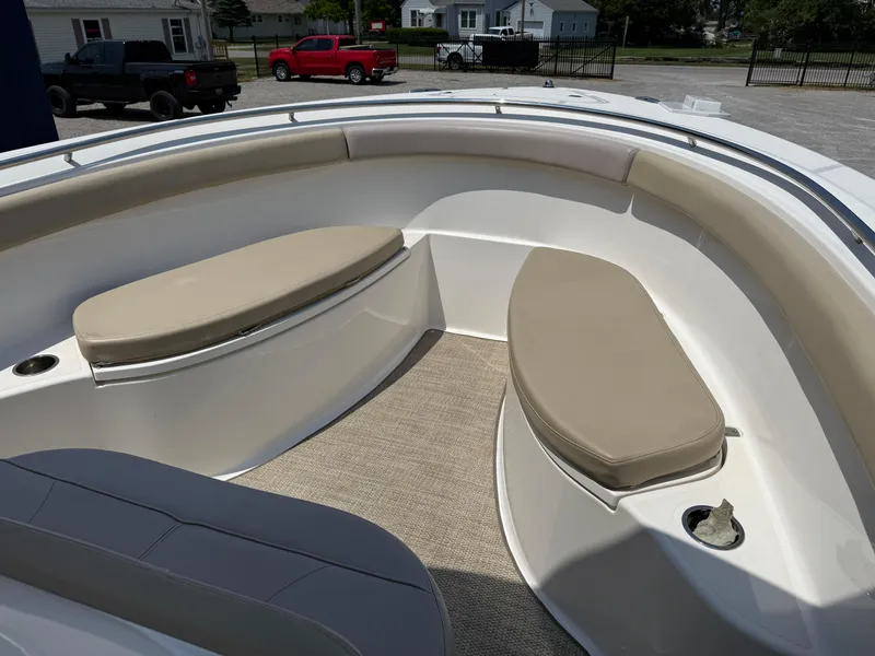 Slide: The Image of 2015 Pursuit S 280 Sport boat interior with cushioned seating and cup holders. - 10