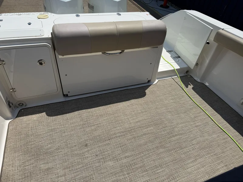 Slide: The Image of 2015 Pursuit S 280 Sport boat interior with cushioned seating and storage compartments. - 12