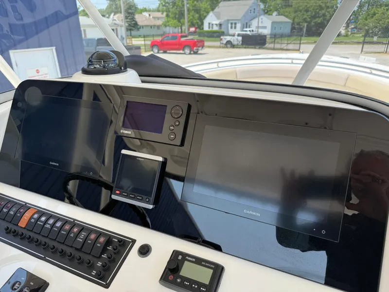 Slide: The Image of Control panel of a 2015 Pursuit S 280 Sport boat with Garmin displays. - 14