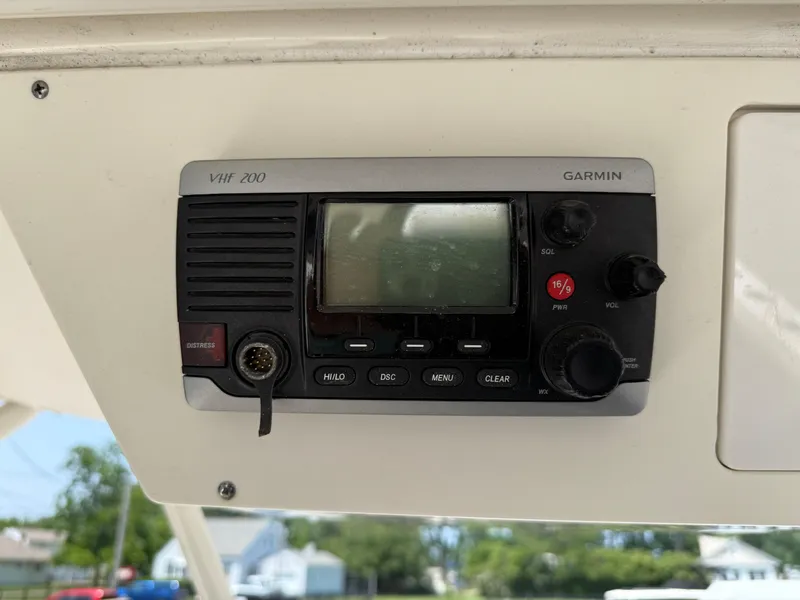 Slide: The Image of Garmin VHF 200 radio on 2015 Pursuit S 280 Sport boat dashboard. - 16
