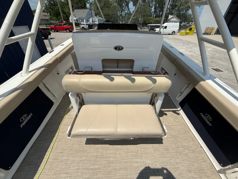 Slide: The Image of 2015 Pursuit S 280 Sport boat interior with beige seating and carpet. - 21