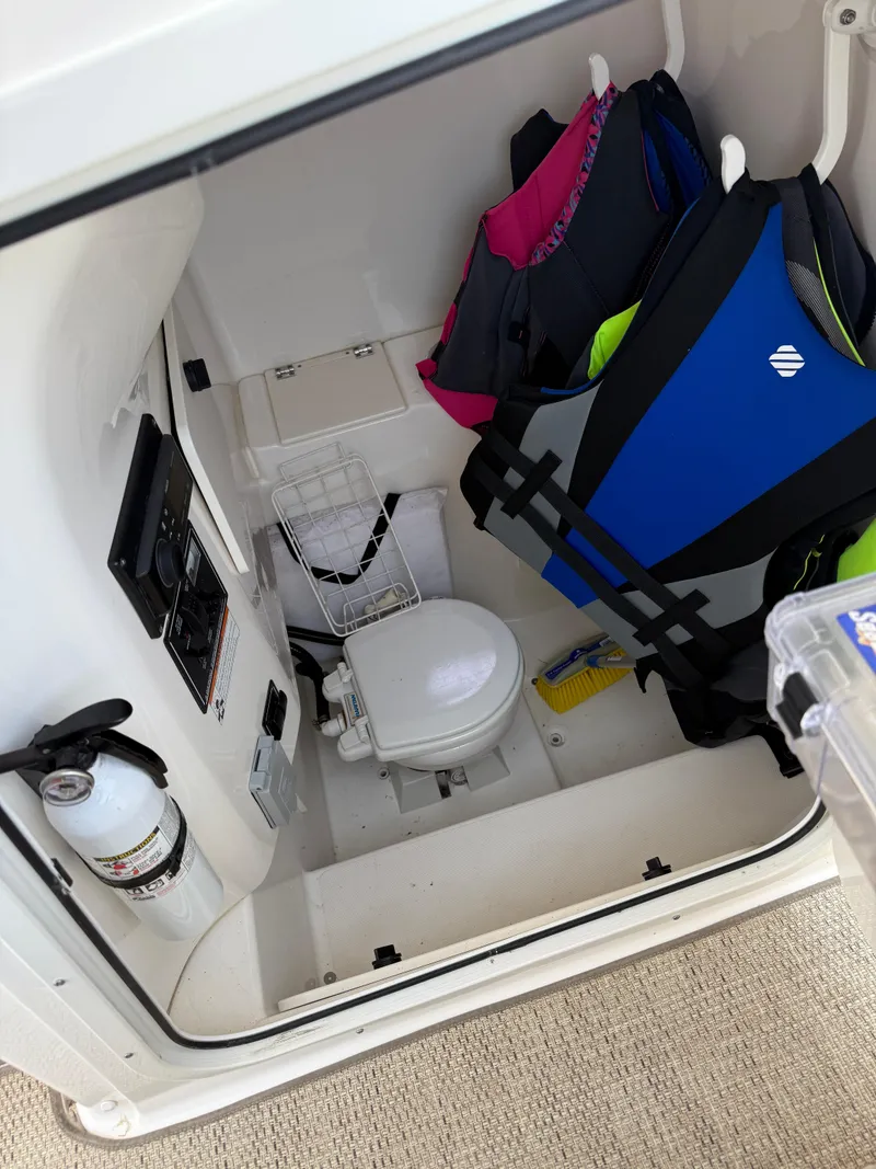 Slide: The Image of 2015 Pursuit S 280 Sport boat interior with toilet and life jackets. - 25