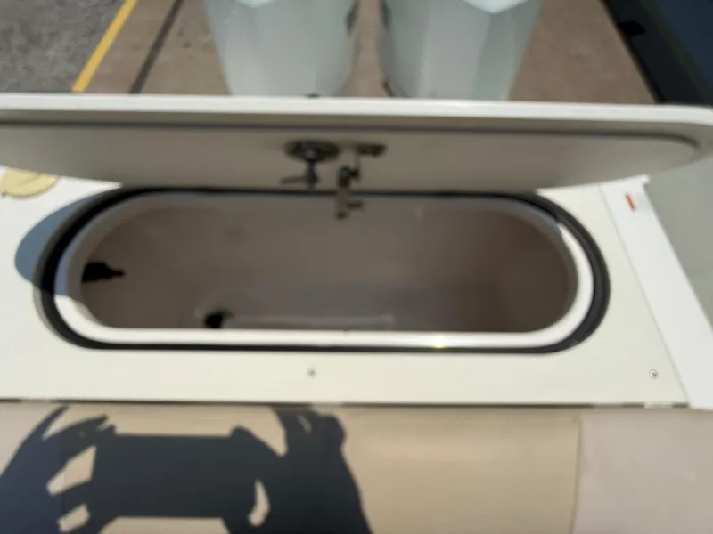 Slide: The Image of Open storage compartment on a 2015 Pursuit S 280 Sport boat. - 27