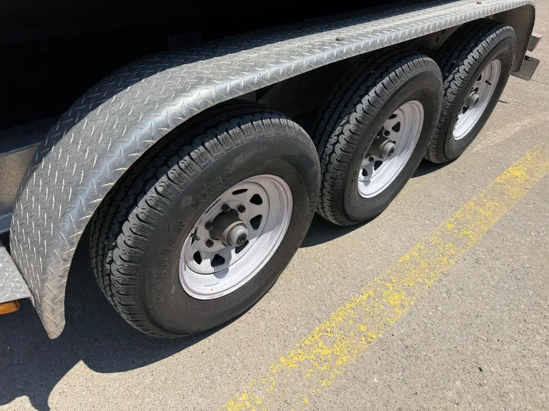 Slide: The Image of Triple-axle trailer with diamond plate fenders, supporting a 2015 Pursuit S 280 Sport. - 6