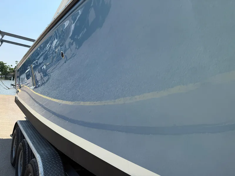 Slide: The Image of 2015 Pursuit S 280 Sport boat on trailer, side view, reflecting surroundings. - 8