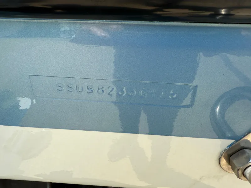 Slide: The Image of 2015 Pursuit S 280 Sport boat hull identification number (SSUS8236415) embossed on blue surface. - 9