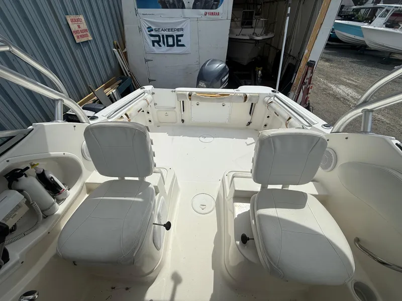 Slide: The Image of 2005 Wellcraft 252 Coastal boat interior with white seating and Yamaha engine in background. - 12