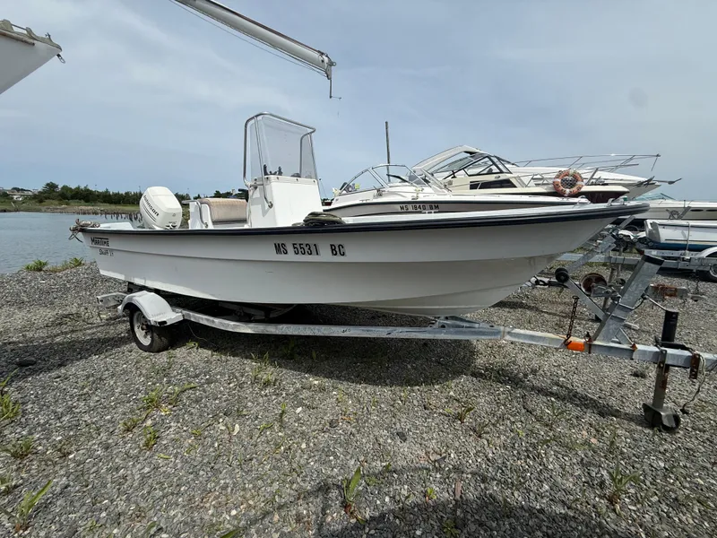 Slide: The Image of 2002 Maritime Skiff 1890 boat on trailer by waterfront, ready for launch. - 0