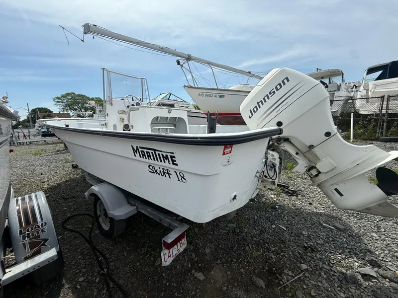 Slide: The Image of 2002 Maritime Skiff 1890 boat with Johnson outboard motor on trailer. - 1