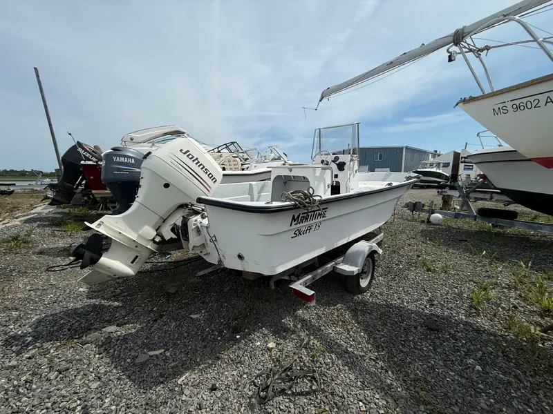 Slide: The Image of 2002 Maritime Skiff 1890 boat with Johnson outboard motor on a trailer. - 2