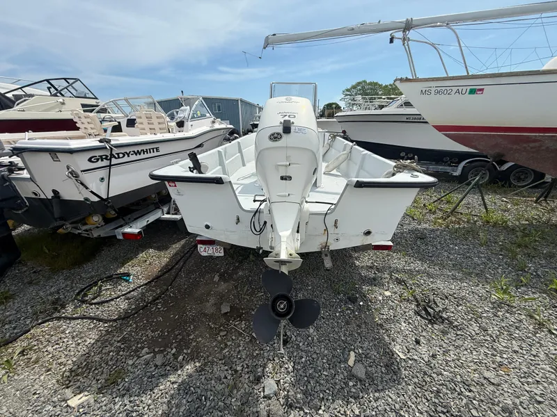 Slide: The Image of 2002 Maritime Skiff 1890 boat with outboard motor, parked on gravel lot. - 4