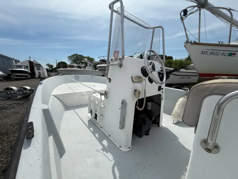 Slide: The Image of 2002 Maritime Skiff 1890 boat with center console, parked outdoors under clear sky. - 6