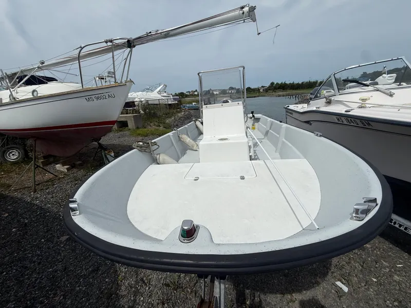 Slide: The Image of 2002 Maritime Skiff 1890 boat on gravel, surrounded by other boats. - 8