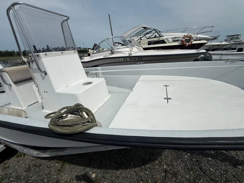 Slide: The Image of 2002 Maritime Skiff 1890 boat docked, featuring a clean deck and coiled rope. - 9