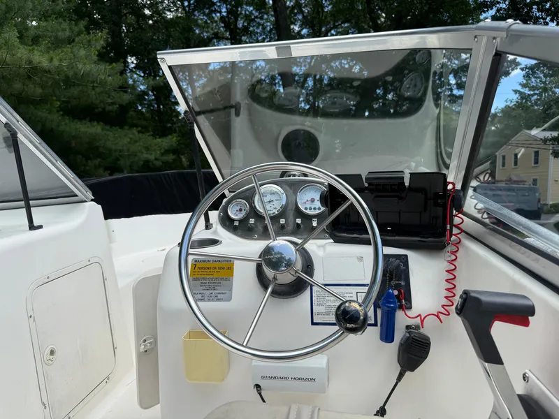 Slide: The Image of 2005 Sea Hunt Escape 200 boat dashboard with steering wheel and gauges. - 12