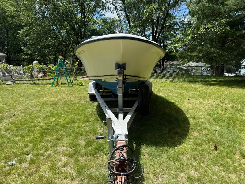 Slide: The Image of 2005 Sea Hunt Escape 200 boat on trailer in grassy yard with trees. - 4