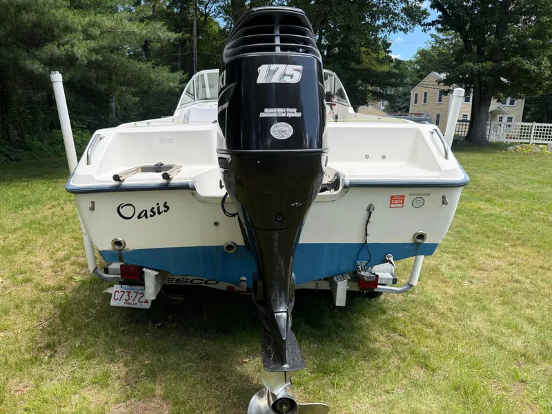 Slide: The Image of 2005 Sea Hunt Escape 200 boat with outboard motor on grassy area. - 7