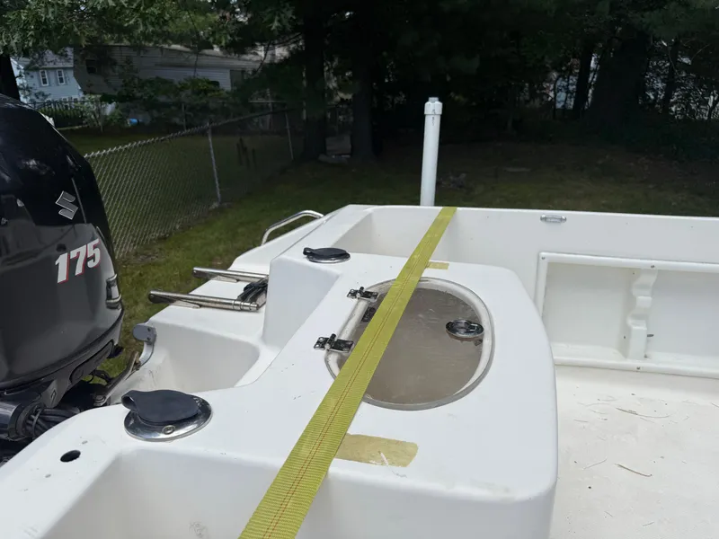 Slide: The Image of 2005 Sea Hunt Escape 200 boat with Suzuki 175 engine, parked in a backyard. - 9