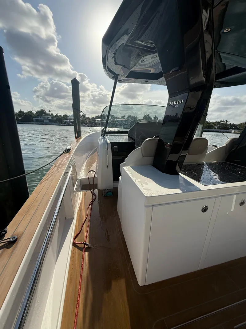 Slide: The Image of 2022 Pardo Yachts 38 docked, showcasing sleek design and modern features under a sunny sky. - 14