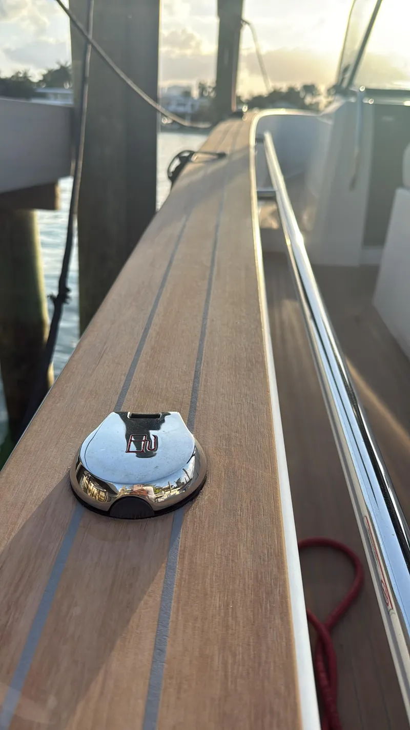 Slide: The Image of Pardo Yachts 38 (2022) deck detail with sleek wood finish and chrome accents. - 8