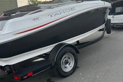 Slide: The Image of 2023 Tahoe 185 S boat on trailer, black and white design, parked outdoors. - 6