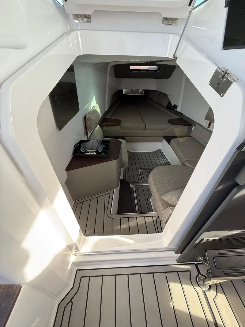 Slide: The Image of 2023 Axopar 37 Cross Cabin interior with modern seating and sleek design. - 22