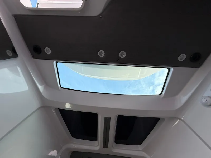 Slide: The Image of Interior view of 2023 Axopar 37 Cross Cabin with skylight and modern design. - 32