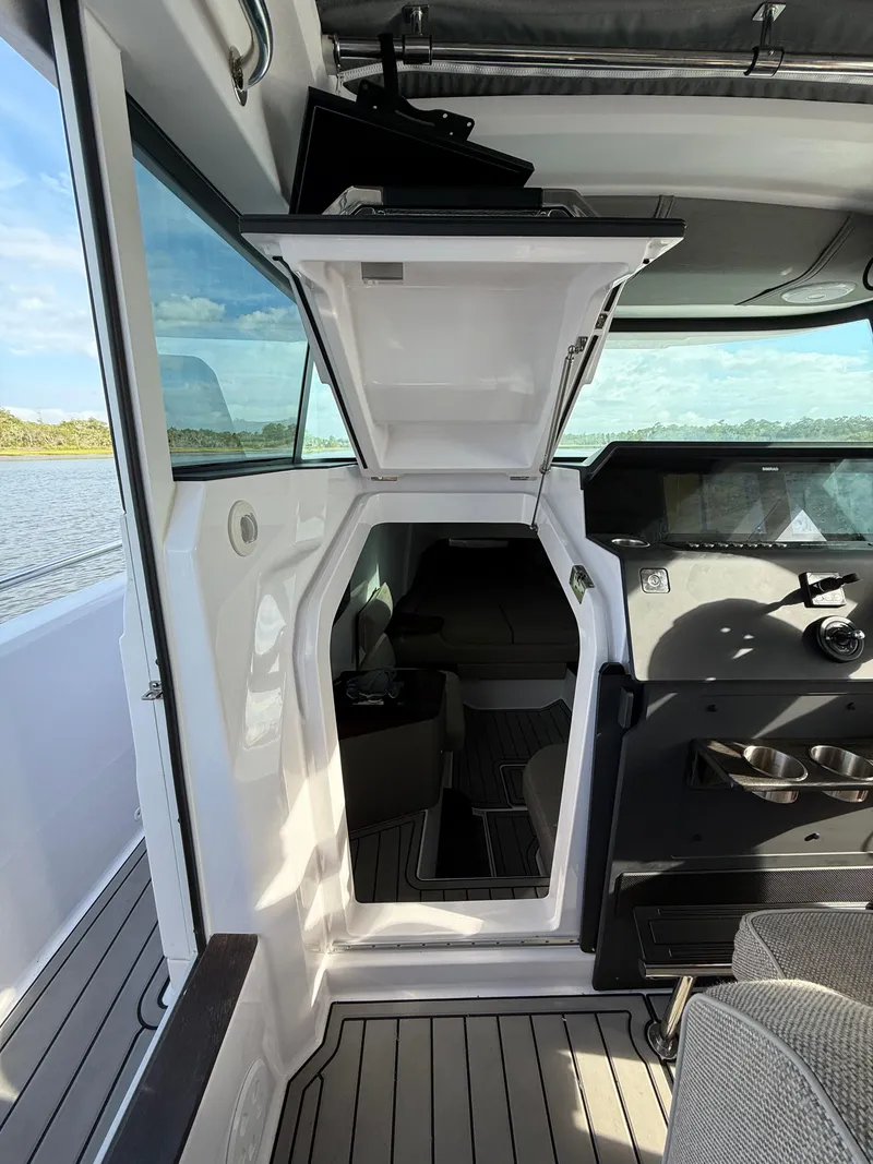 Slide: The Image of 2023 Axopar 37 Cross Cabin interior with open hatch, showcasing sleek design and modern features. - 33