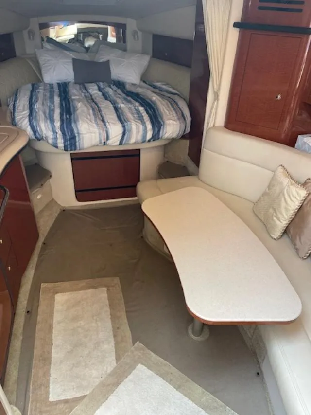 Slide: The Image of Interior of 2004 Sea Ray 320 Sundancer with cozy bed and seating area. - 11
