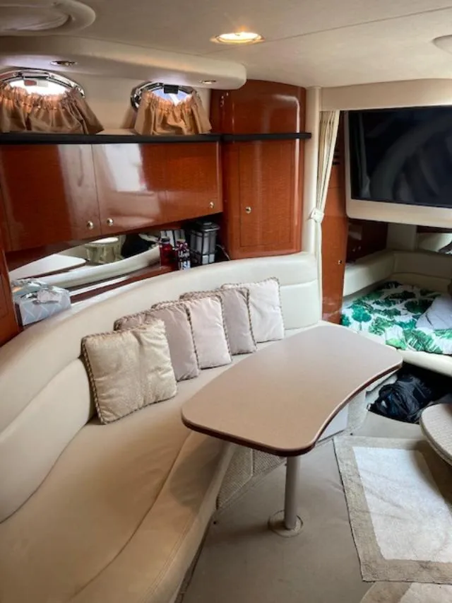 Slide: The Image of Luxurious interior of 2004 Sea Ray 320 Sundancer with plush seating and elegant wood cabinetry. - 12