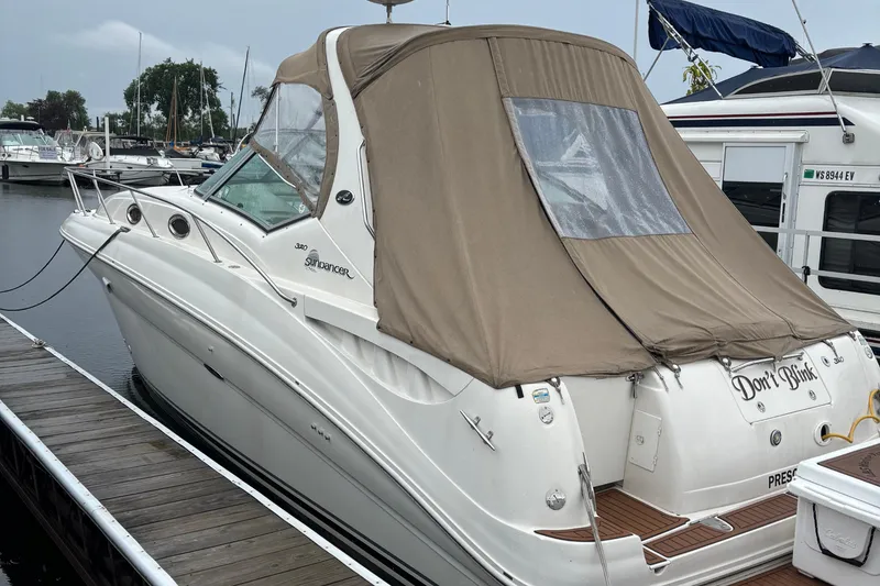 Slide: The Image of 2004 Sea Ray 320 Sundancer docked with tan canvas cover. - 28
