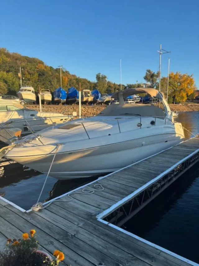 Slide: The Image of 2004 Sea Ray 320 Sundancer docked at a marina under clear blue skies. - 4