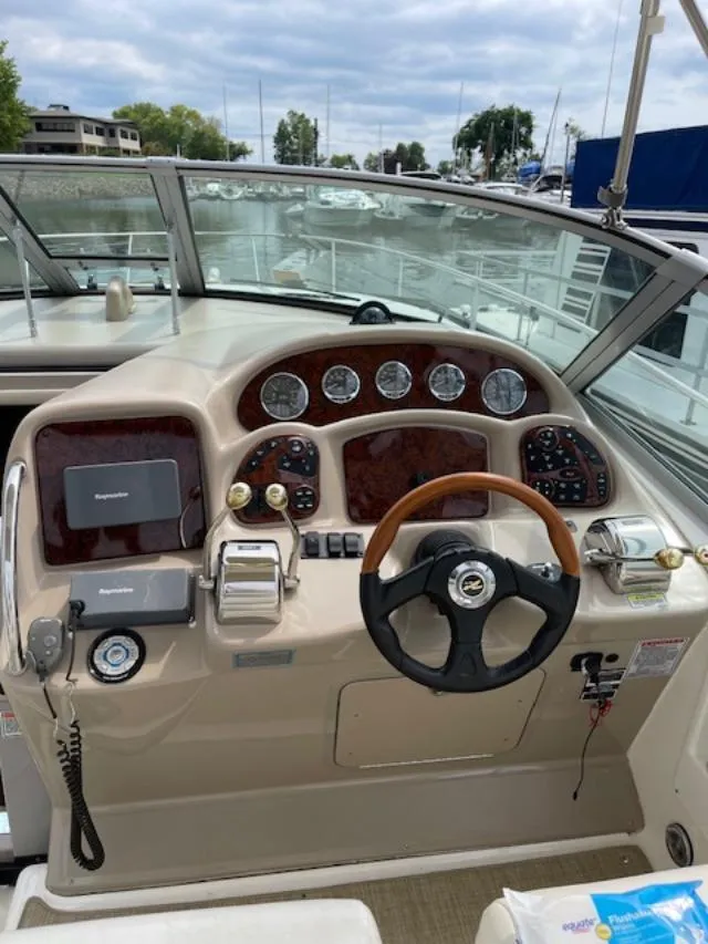 Slide: The Image of 2004 Sea Ray 320 Sundancer helm with steering wheel, gauges, and navigation equipment. - 7