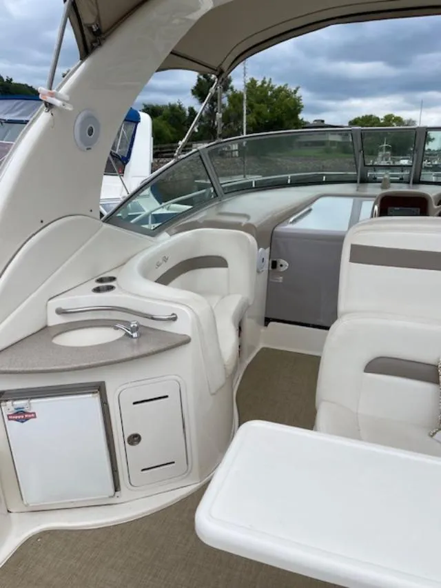 Slide: The Image of 2004 Sea Ray 320 Sundancer interior with seating, sink, and storage. - 9