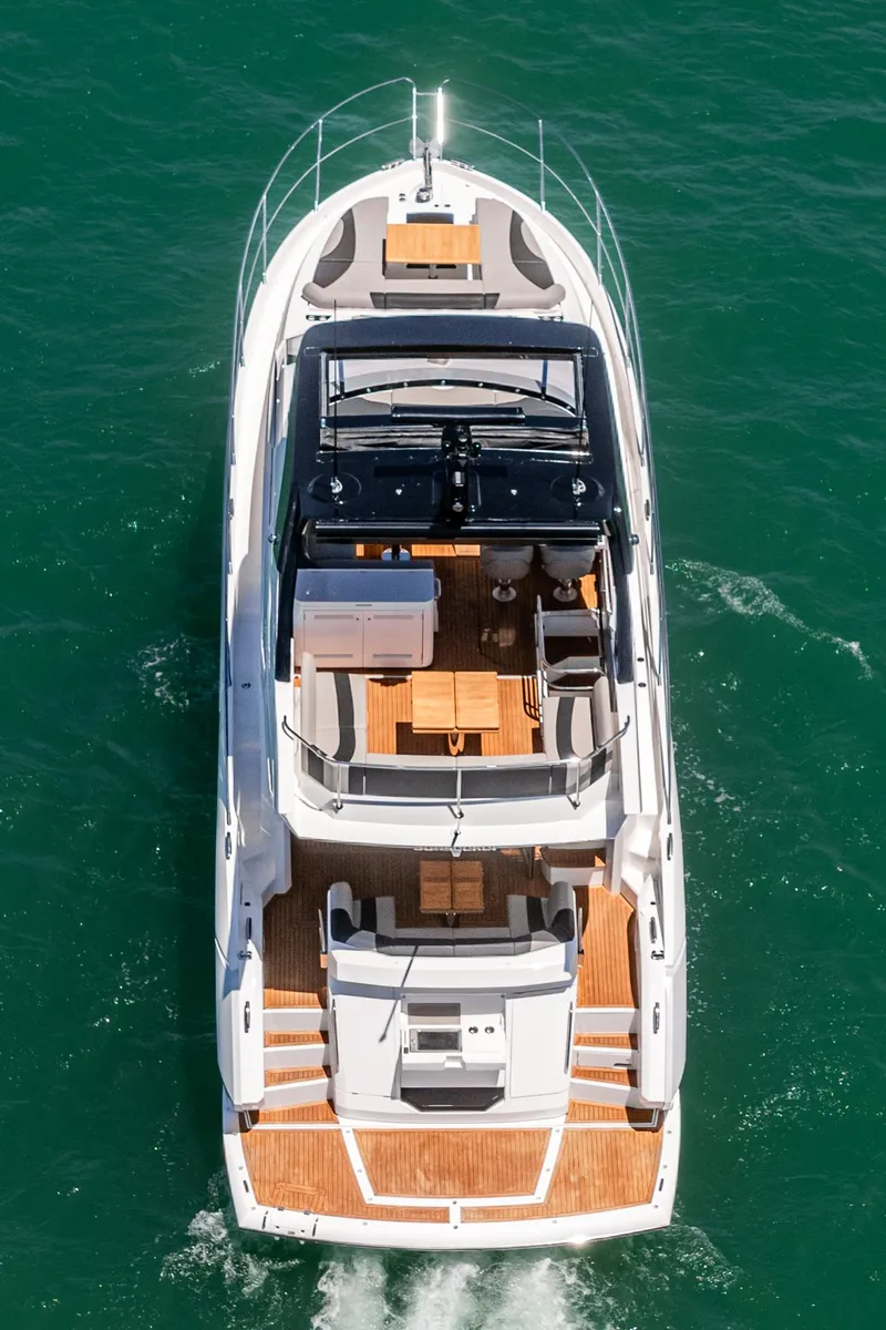 Slide: The Image of 2022 Sunseeker Manhattan 55 yacht cruising on open water, aerial view. - 11