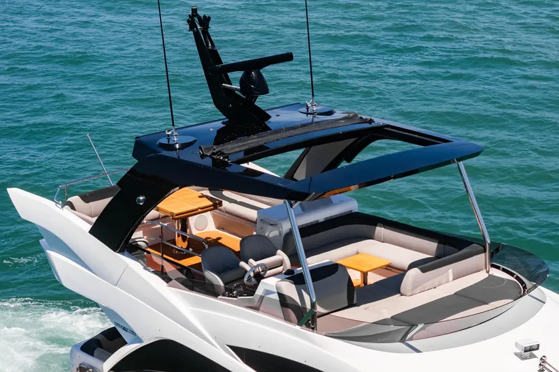 Slide: The Image of 2022 Sunseeker Manhattan 55 yacht cruising on open water, featuring a spacious deck. - 12