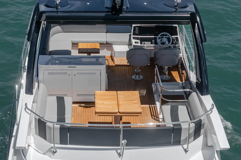 Slide: The Image of Luxurious 2022 Sunseeker Manhattan 55 yacht interior with elegant seating and wooden tables. - 15